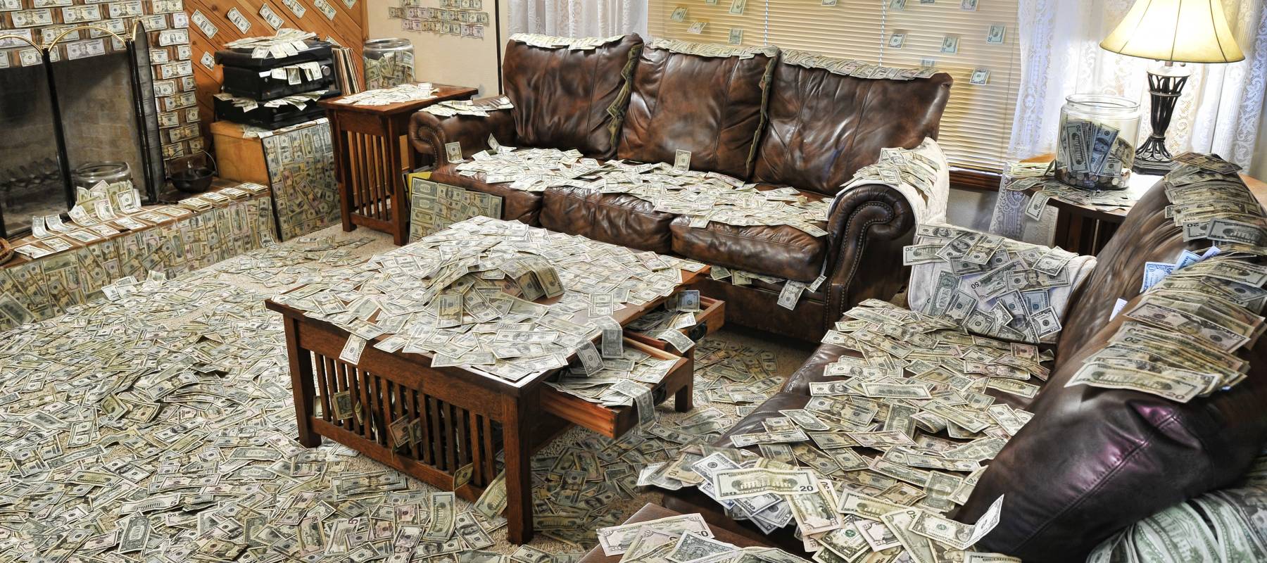 Living room furniture is covered in U.S. cash.