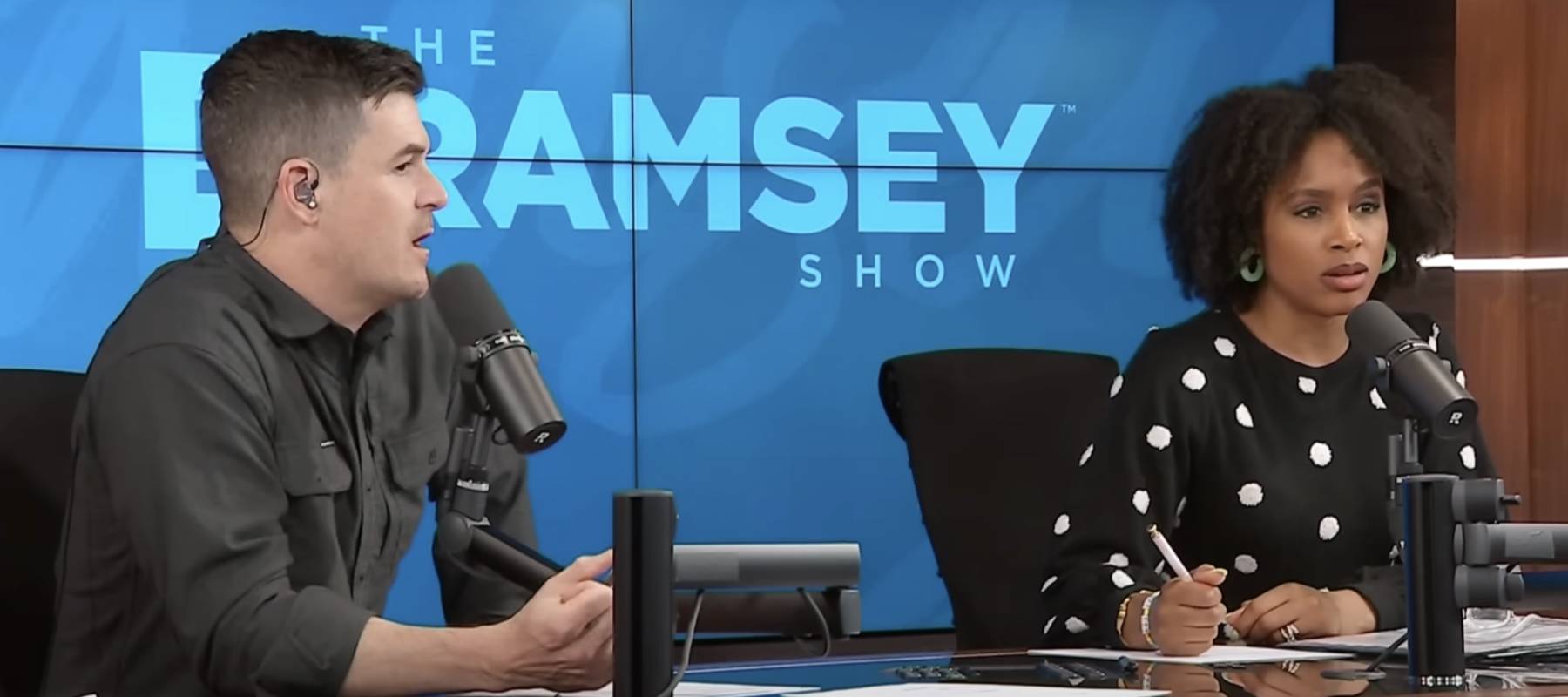 Man and woman seen on set of Dave Ramsey's radio show, looking shocked.