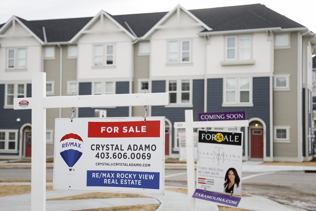 The Calgary Real Estate Board says March home sales were up 9.9 per cent from last year as interprovincial migration to Alberta contributed to tight market conditions. Houses for sale in a ne