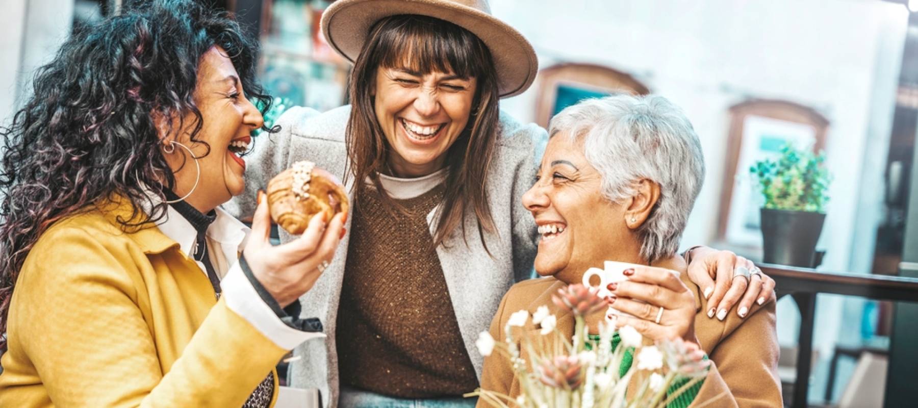 three senior women enjoying breakfast drinking coffee at bar cafeteria