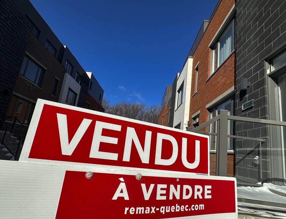 A &quot;sold&quot; sign is shown in a new housing development in Lasalle, a borough of Montreal, Monday, Feb. 19, 2024. The Quebec Professional Association of Real Estate Brokers says Montreal-area hom