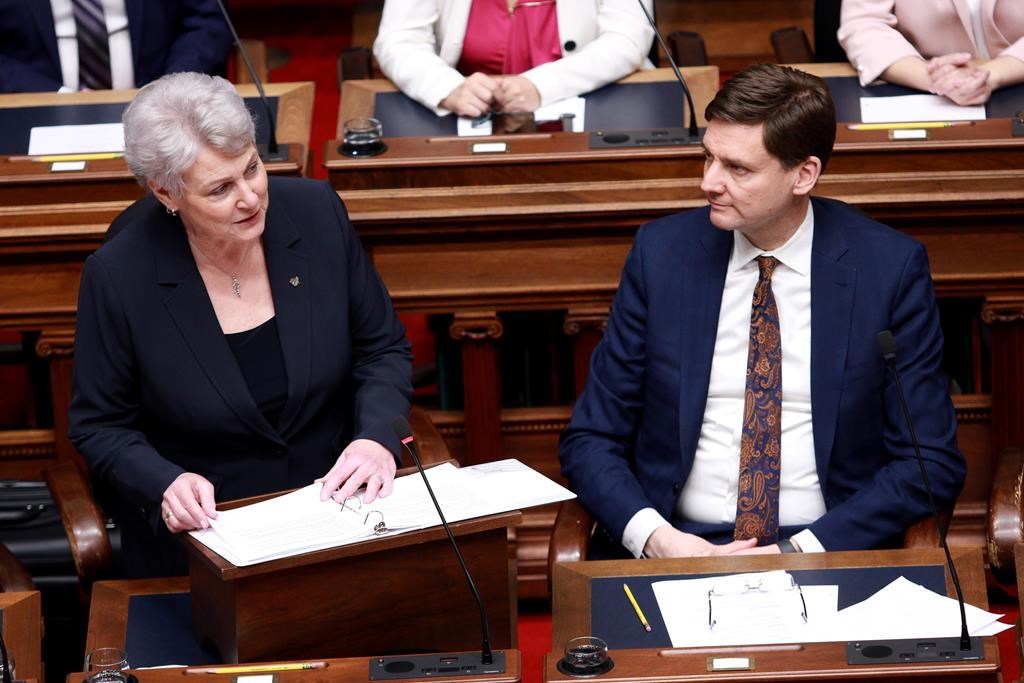 Finance Minister Katrine Conroy tables the budget as Premier David Eby looks on from the legislative assembly at the legislature in Victoria on Feb. 22, 2024. 