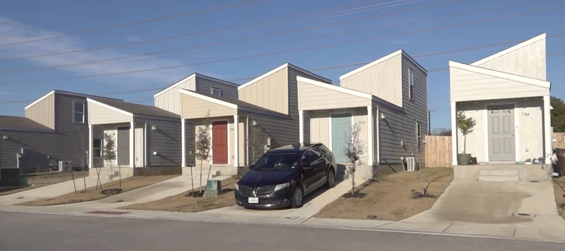 View from the street of a row of tiny houses in San Antonio, Texas.