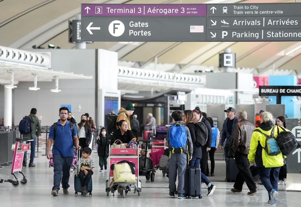 People are shown at Pearson International Airport in Toronto on Friday, March 10, 2023. Toronto&#039;s airport authority is planning to invest in Pearson Airport as it expects to welcome more visi
