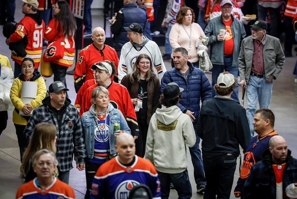 Crowds walk through the concourse before the start of a Calgary Flames game in Calgary, Saturday, April 6, 2024.