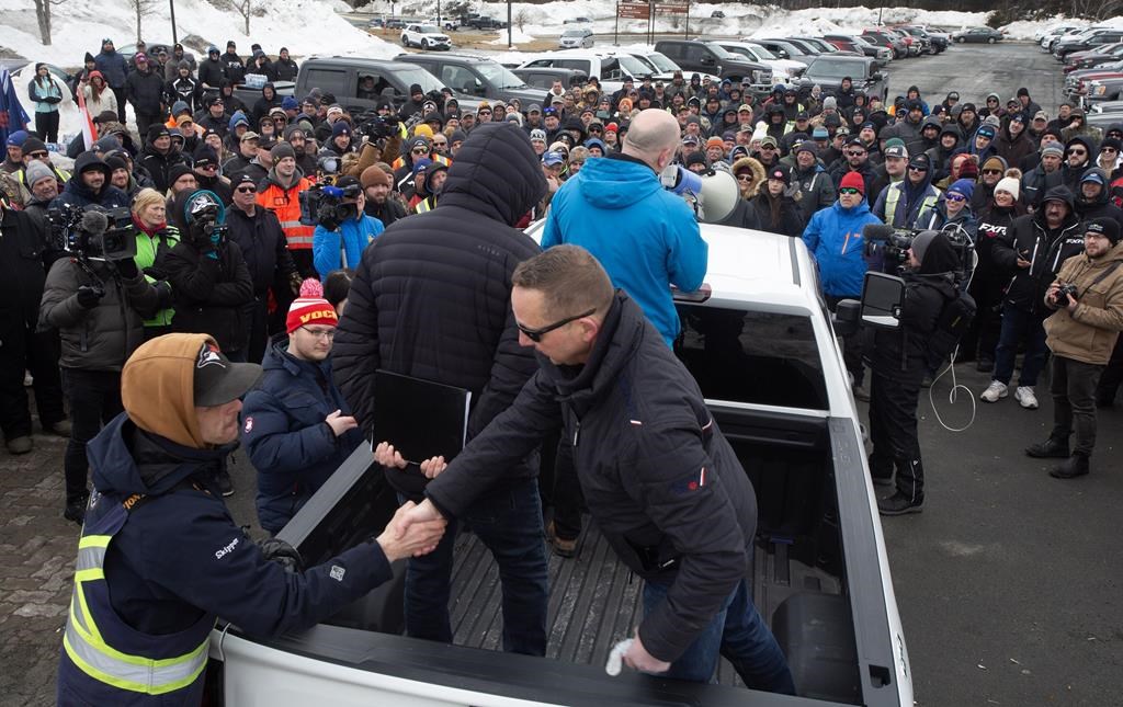 John Efford Jr. shakes hands with a fellow harvester as FFAW Secretary-Treasurer, Jason Spingle addresses the fish harvesters gathered outside the Confederation Building in St. John&#039;s, Friday