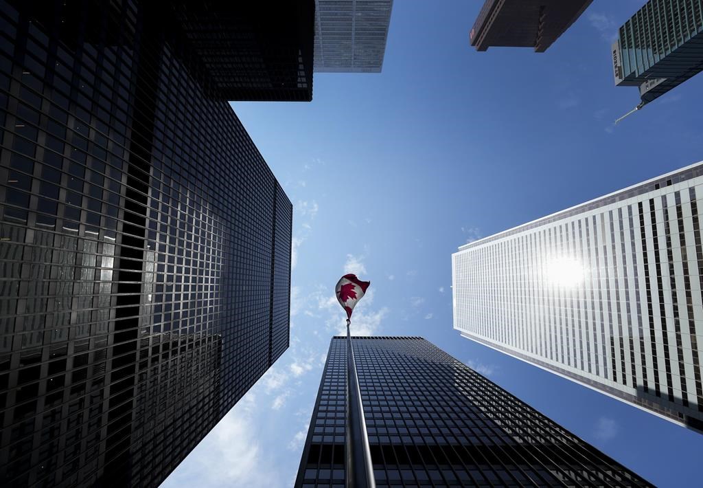 A Canadian flag flies in the Bay Street financial district in Toronto on Friday, August 5, 2022. 