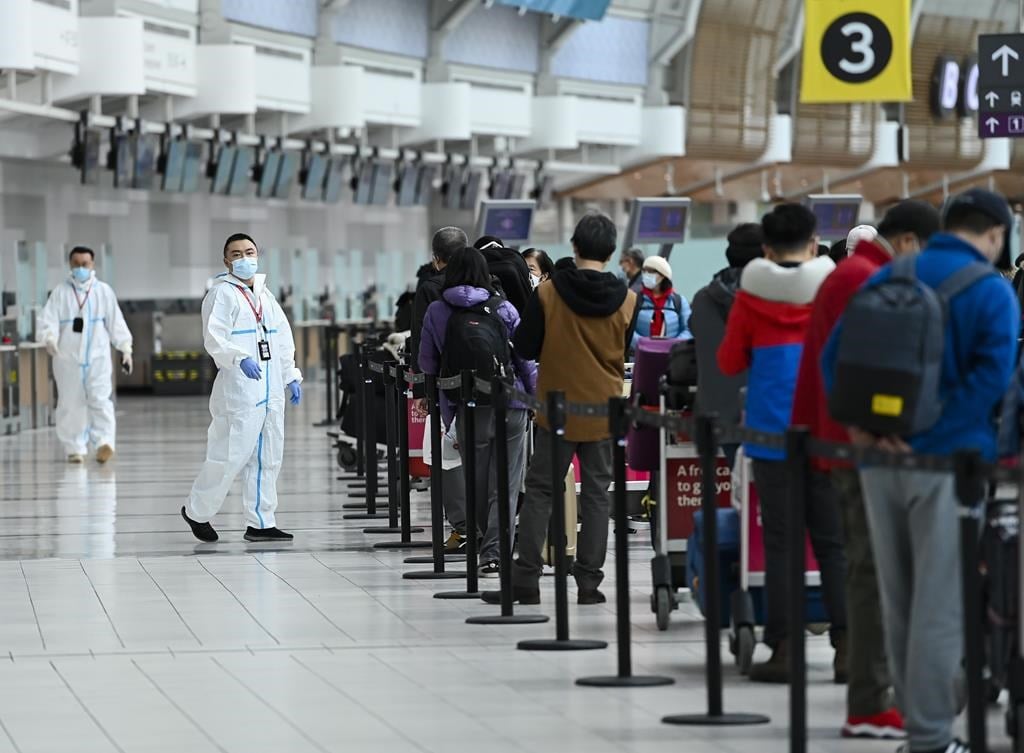 People line up and check in for an international flight at Pearson International Airport during the COVID-19 pandemic in Toronto on Wednesday, Oct. 14, 2020. The federal government and a cons