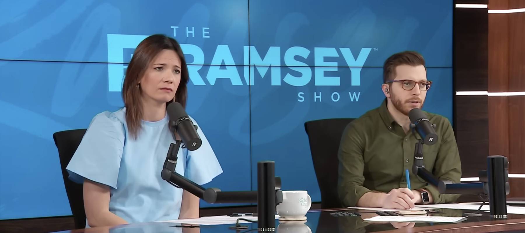 a screengrab of an episode of The Ramsey Show with co-hosts Rachel Cruze and George Kamel