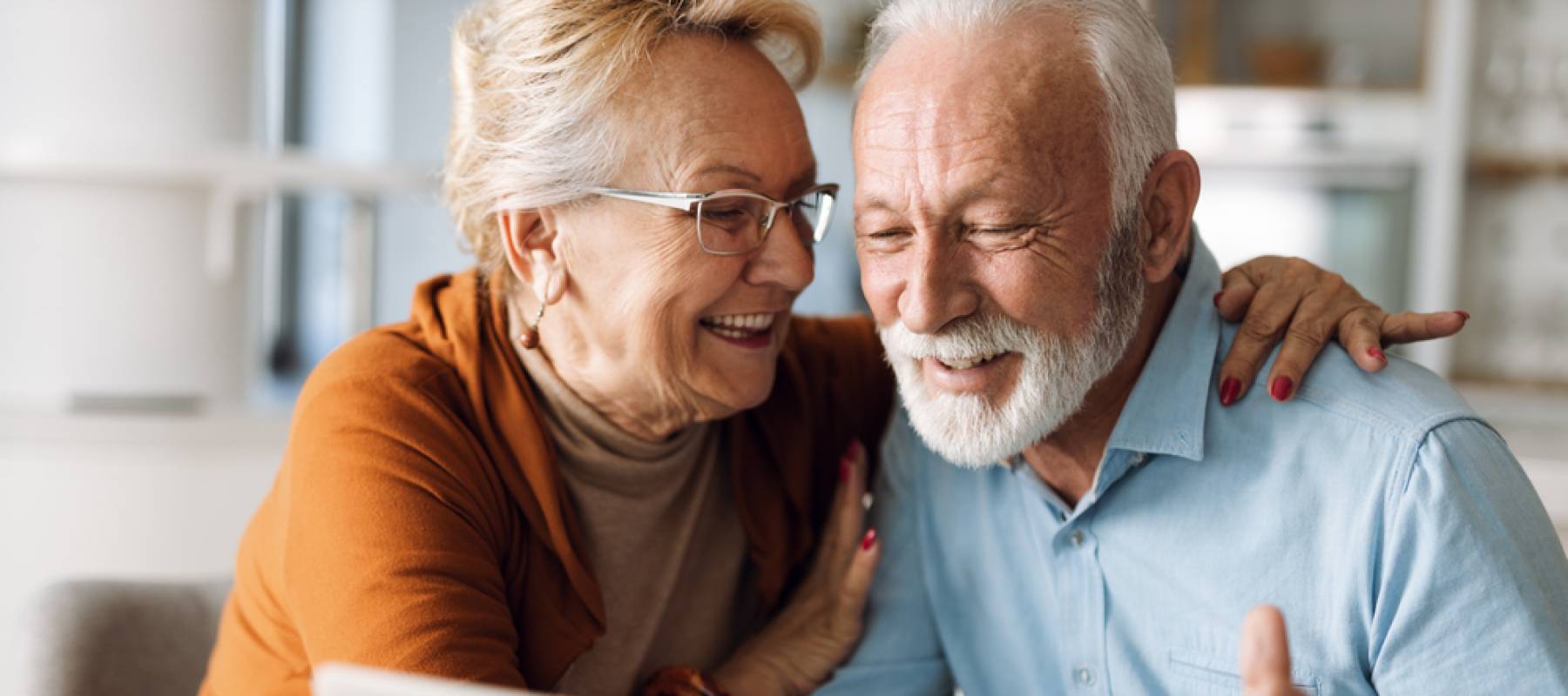 Older couple looking at a laptop
