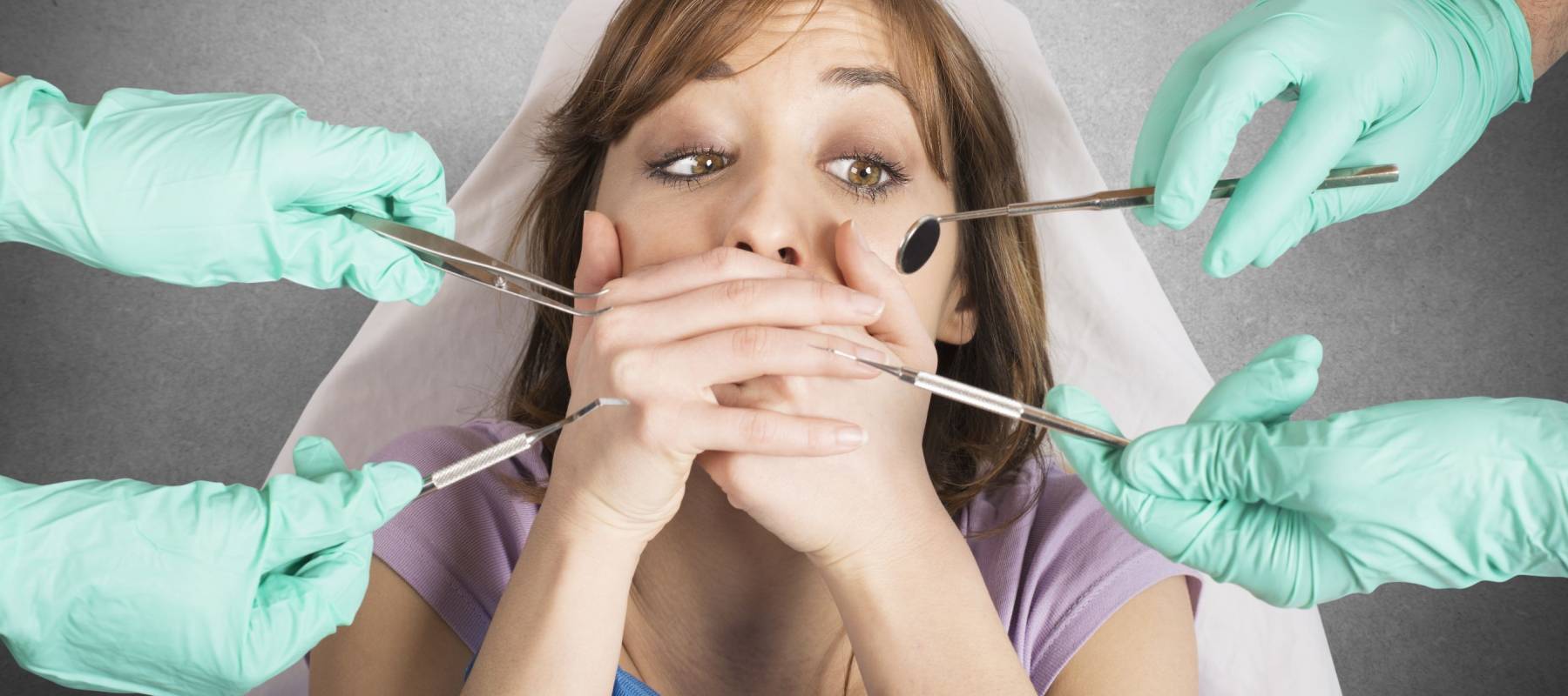 Girl frightened by dentists covers her mouth