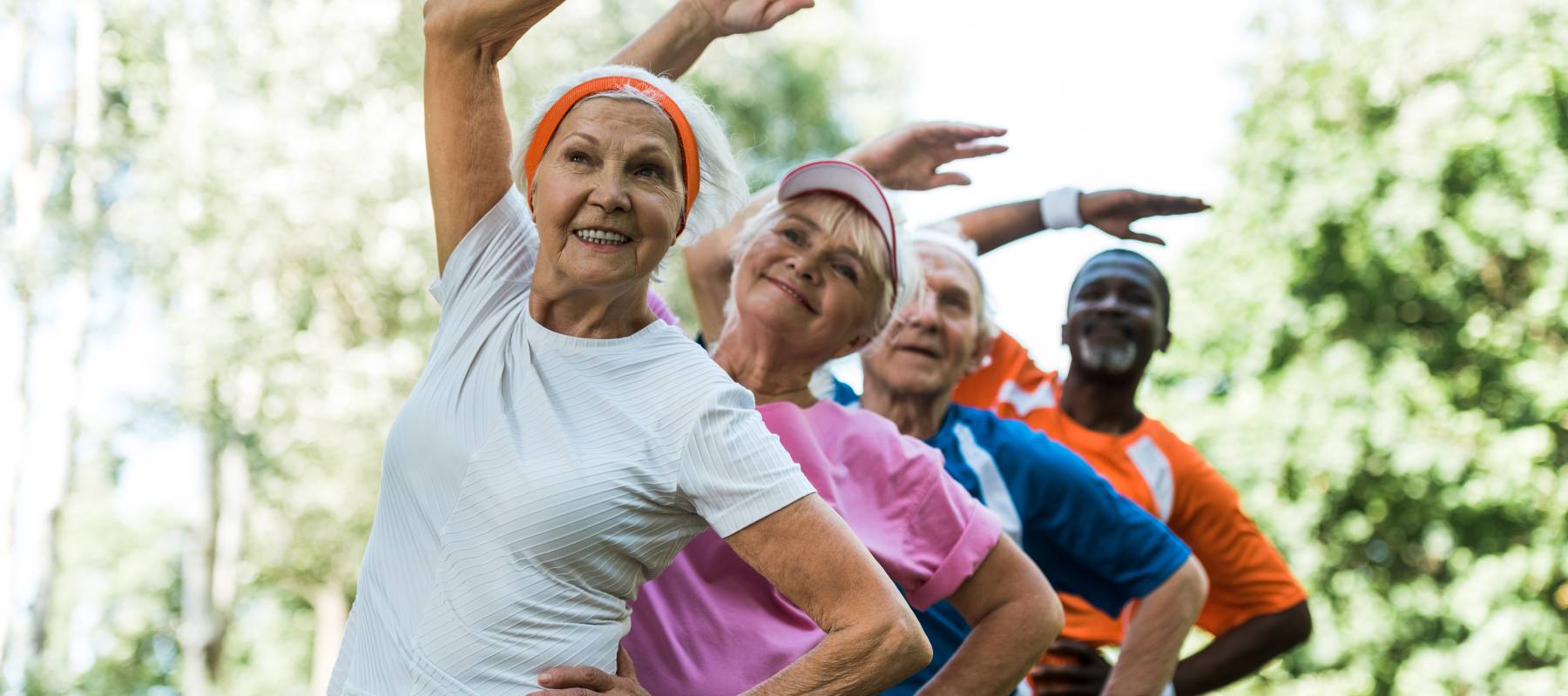 A group of older men and women stretching.