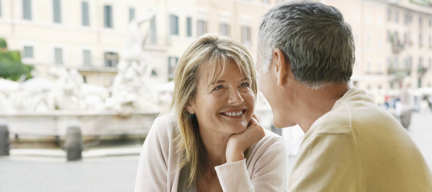 senior Caucasian couple looking at each other at outdoor cafe