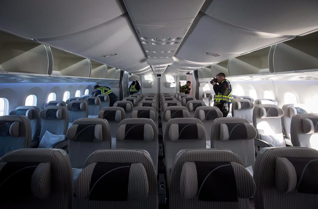 An airplane travelling from Paris to Seattle was forced to make an emergency landing at Iqaluit&amp;rsquo;s airport. Members of the media take photos and record video in the forward economy cabin