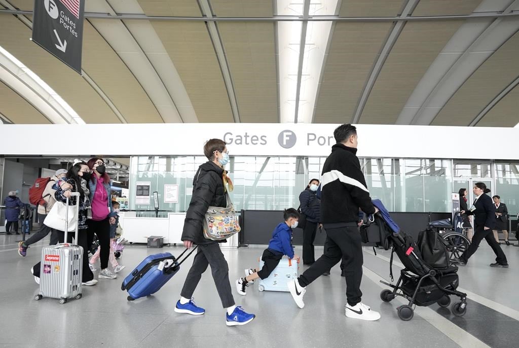 A new survey says Air Canada ranked below most other major North American airlines on customer satisfaction. People walk through Pearson International Airport in Toronto on Friday, March 10, 