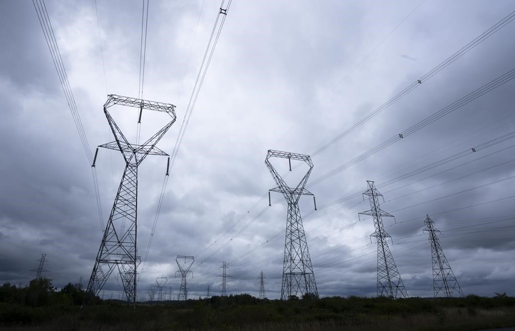 Power lines are seen against cloudy skies near Kingston, Ont. , Wednesday, Sept. 7, 2022 in Ottawa. The Alberta Utilities Commission is fining another power plant in the province for operatin