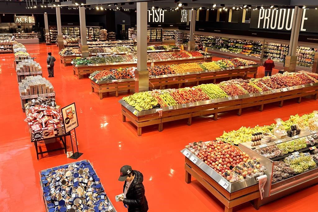 Prime Minister Justin Trudeau says with the biggest Canadian grocer now on board, the grocery code of conduct is much more likely to succeed. Shoppers browse goods in the produce section of a