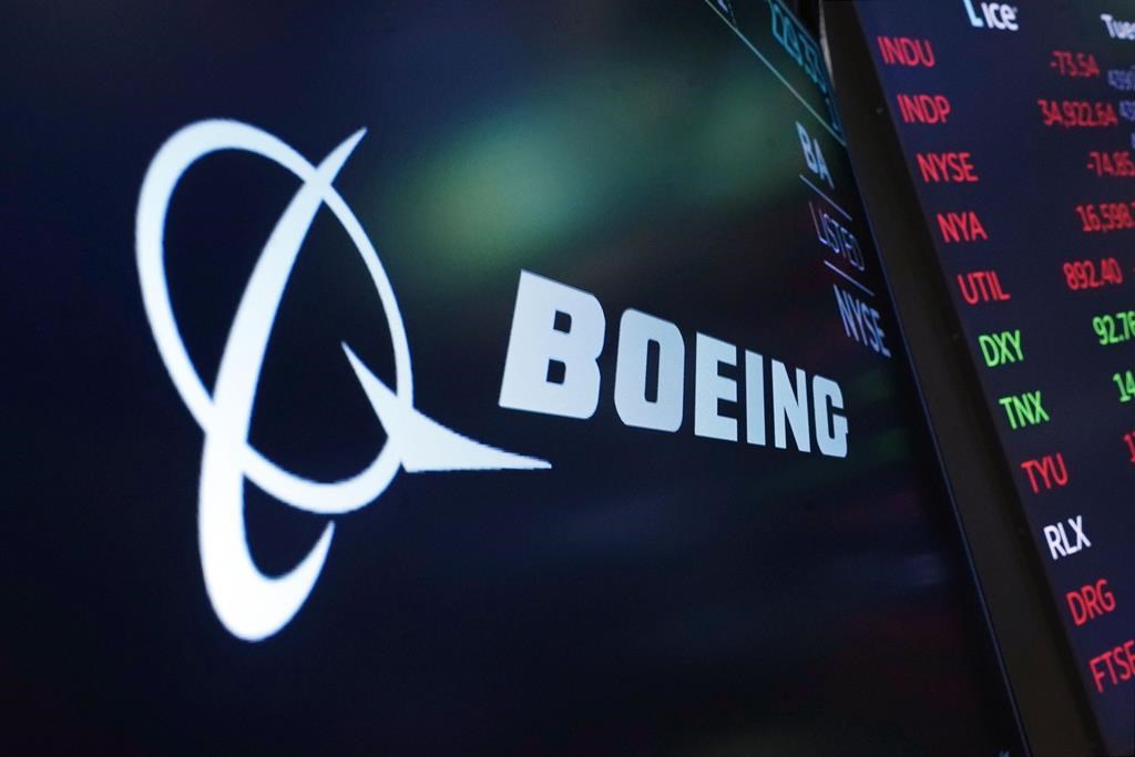 The logo for Boeing appears on a screen above a trading post on the floor of the New York Stock Exchange, July 13, 2021. Boeing Co. is expanding its sizeable footprint in Canada, becoming the