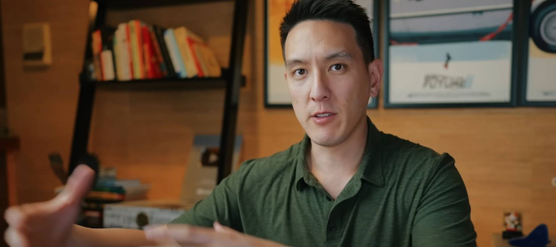 Humphrey Yang seen on set of his YouTube show, in the middle of speaking and gesturing.