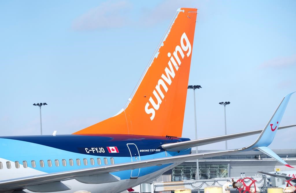A Sunwing aircraft is parked at Montreal Trudeau Airport in Montreal on Wednesday, March 2, 2022. 