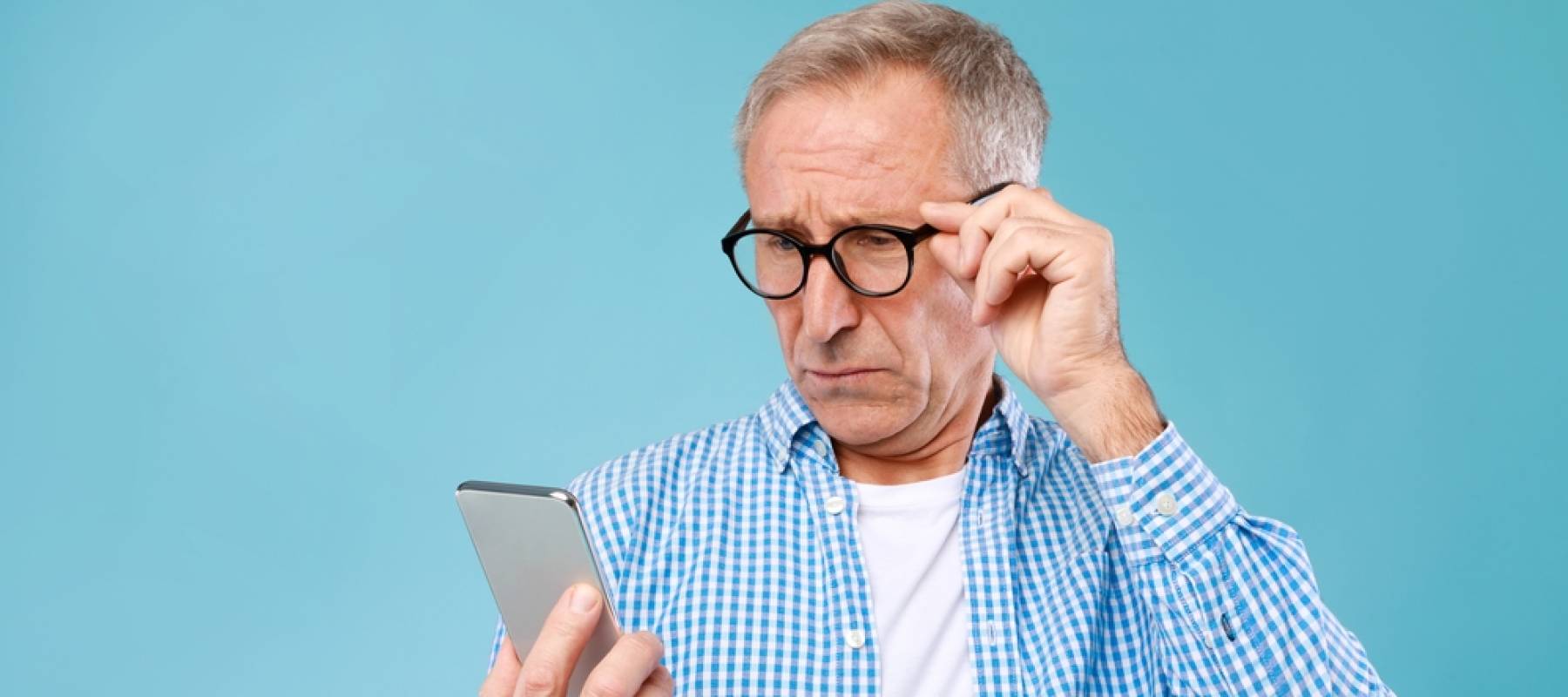 Surprised Mature Man Holding Smartphone