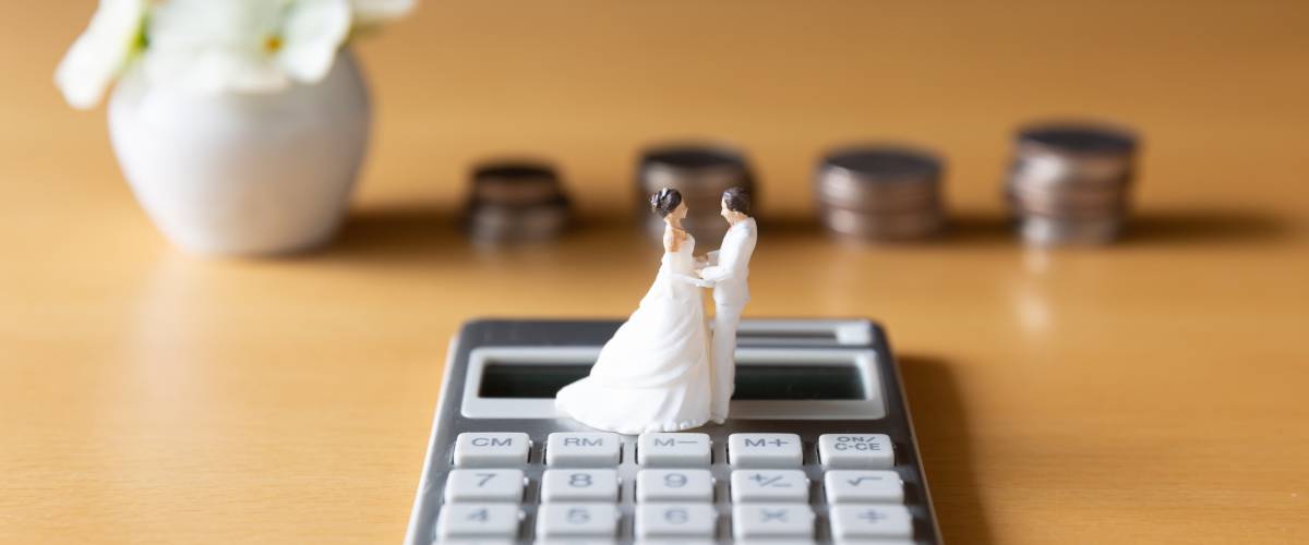 Calculator with bride and groom figurine on top