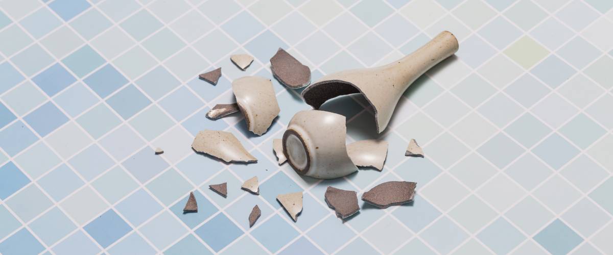 Broken vase on tile floor