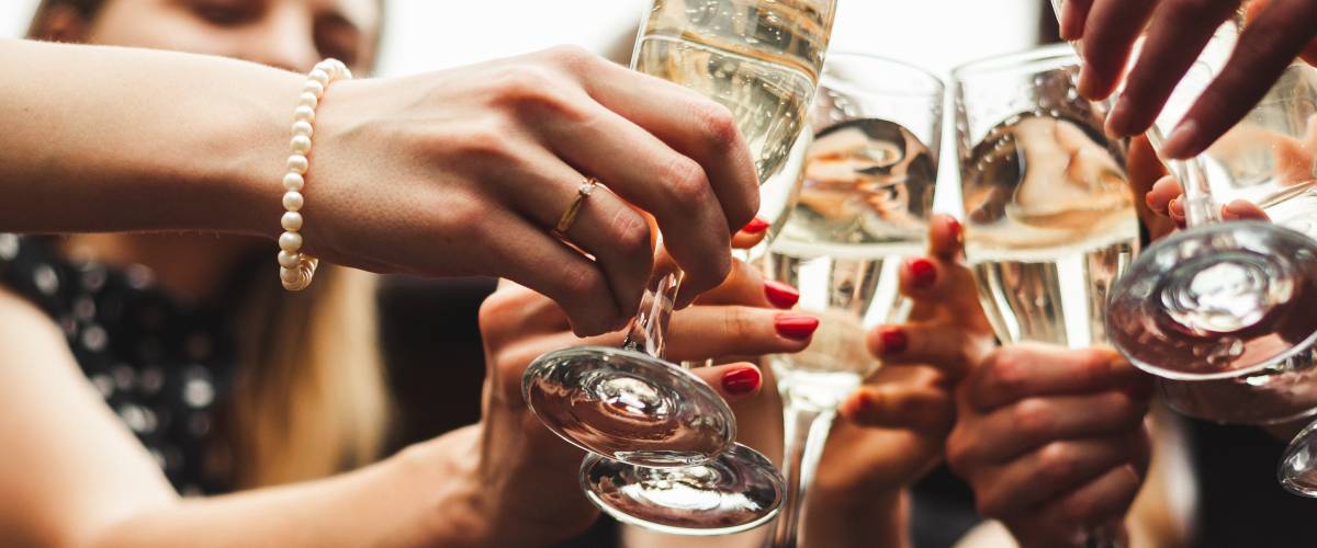 People clinking champagne glasses together