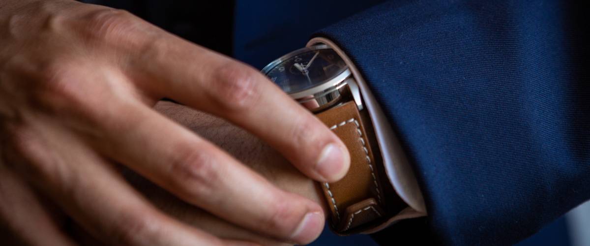 Groom in suit looking at watch