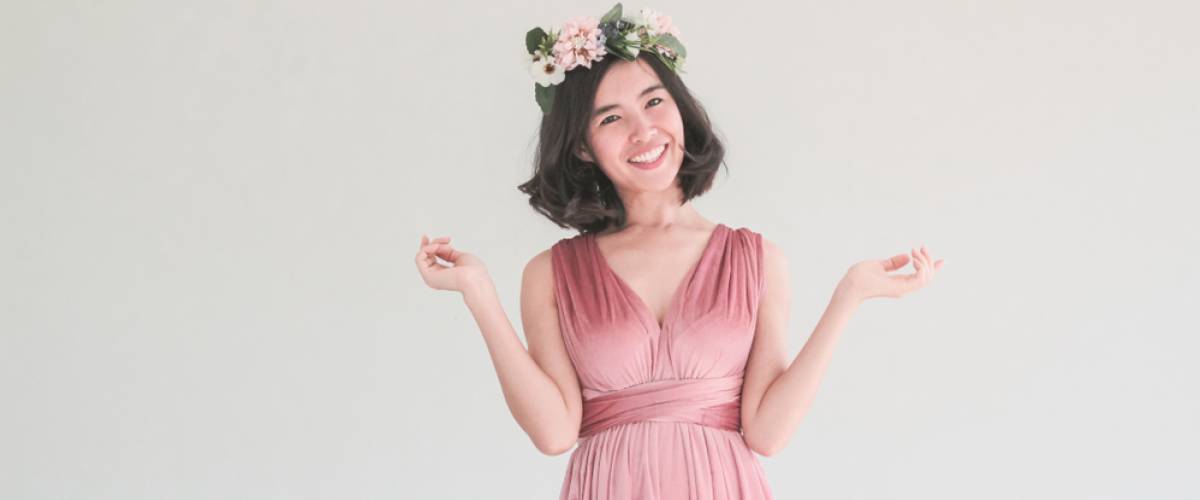 Young woman with short hair in pink bridesmaid dress