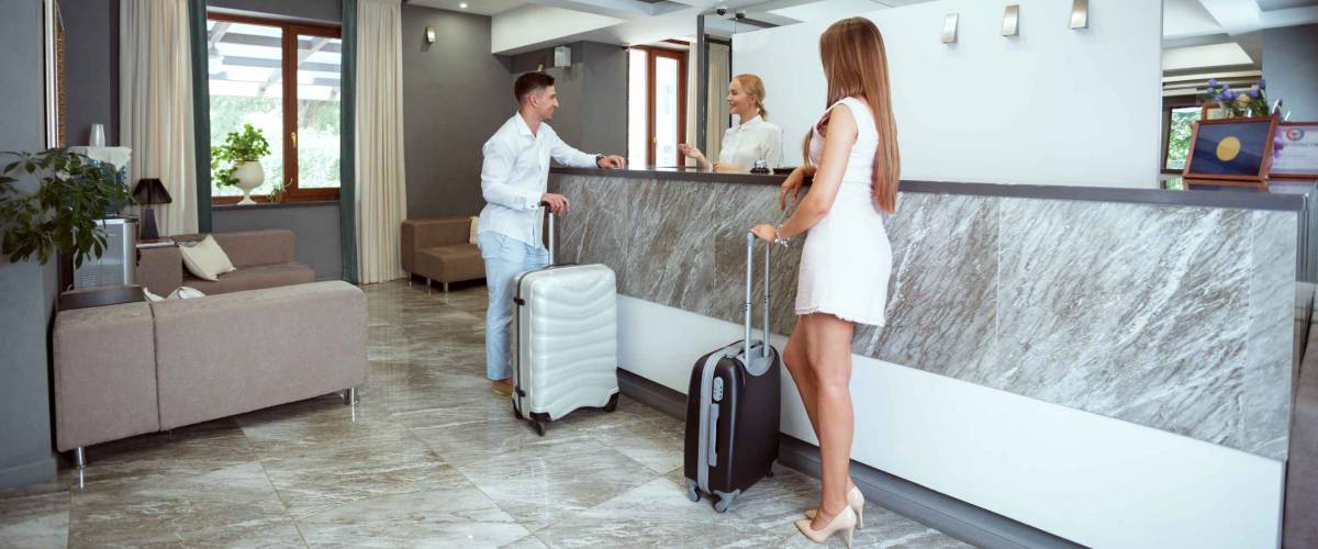 couple near reception desk in hotel