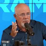Dave Ramsey on set of his radio show, looking concerned and holding one hand up.