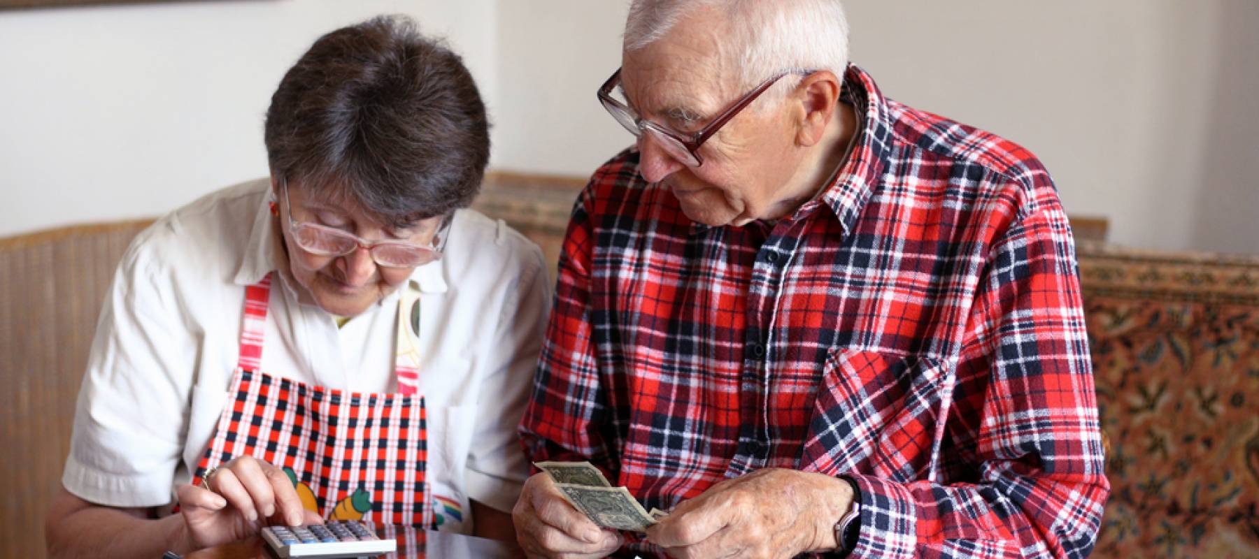 Optimistic European retirees couple counting money