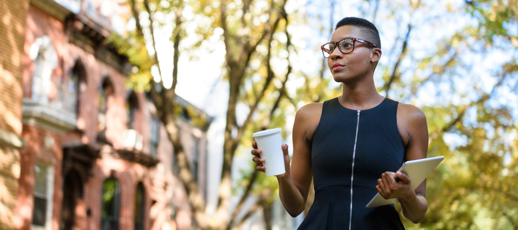 young African business woman walking down the street