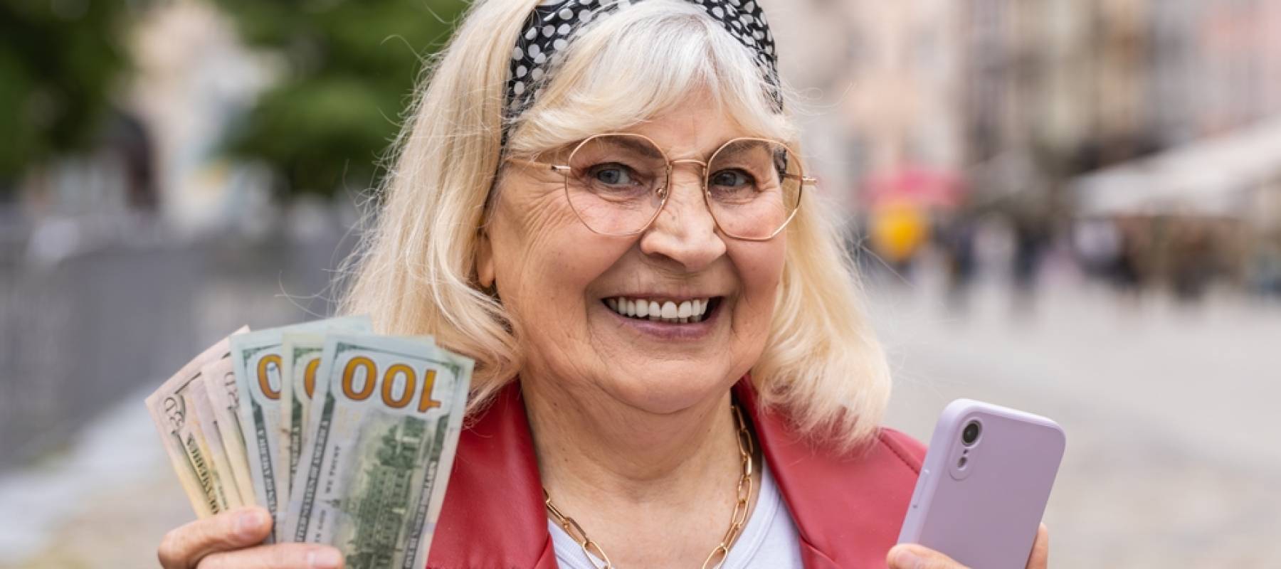 Happy senior woman counting money dollar cash, use smartphone calculator app