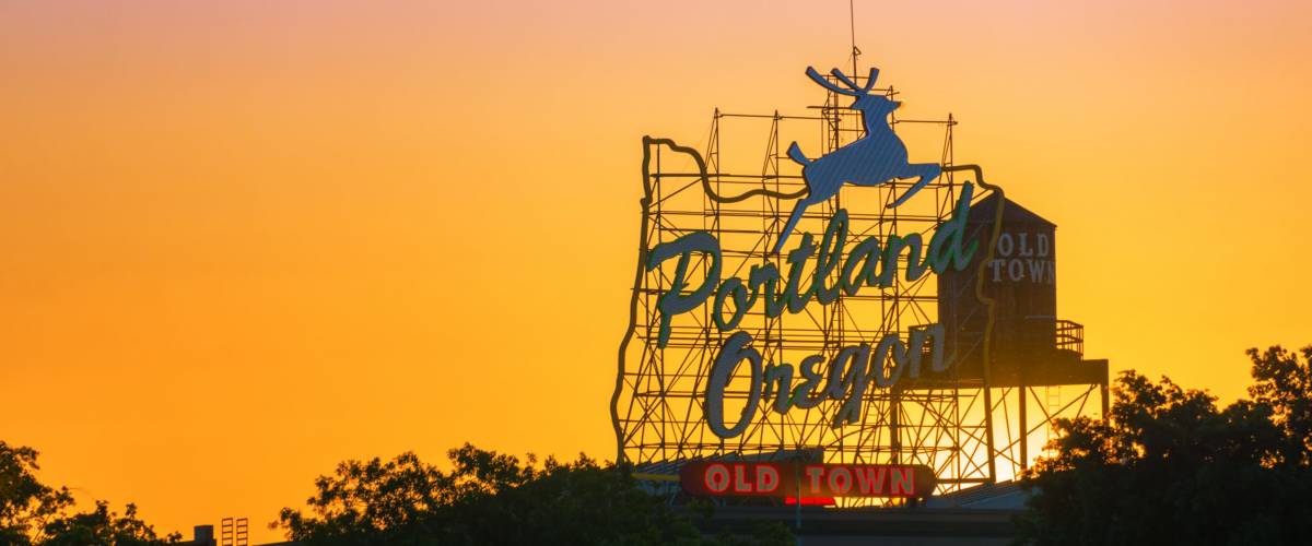 Sunset over the iconic Portland, Oregon Old Town sign in downtown Portland, Oregon