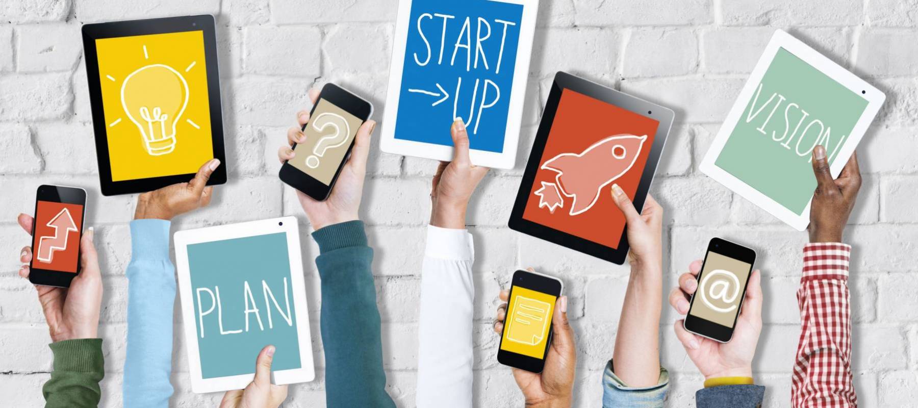 Group of Hands Holding Digital Devices with Startup Concept