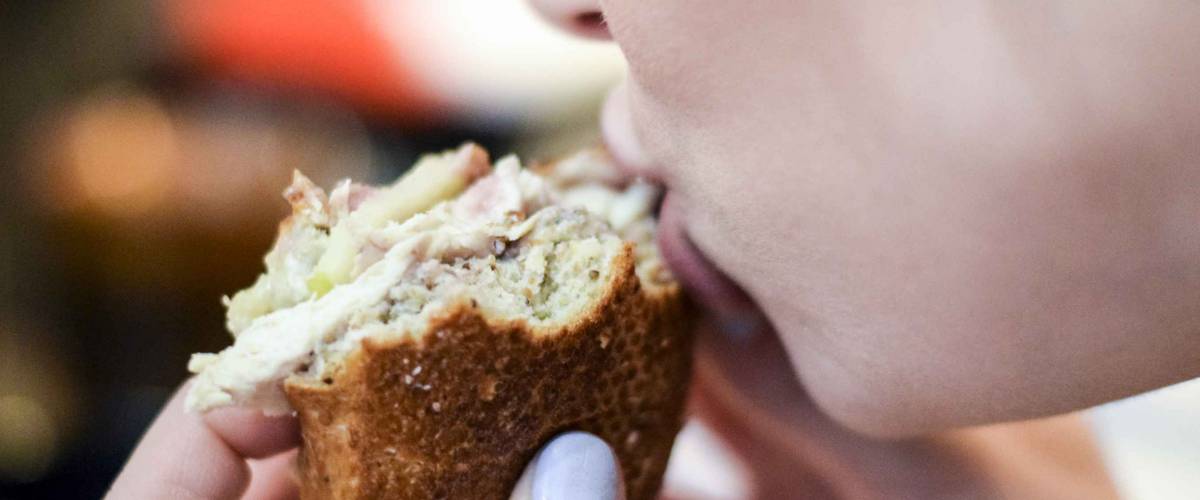Woman taking a bit out of a delicious panini sandwich