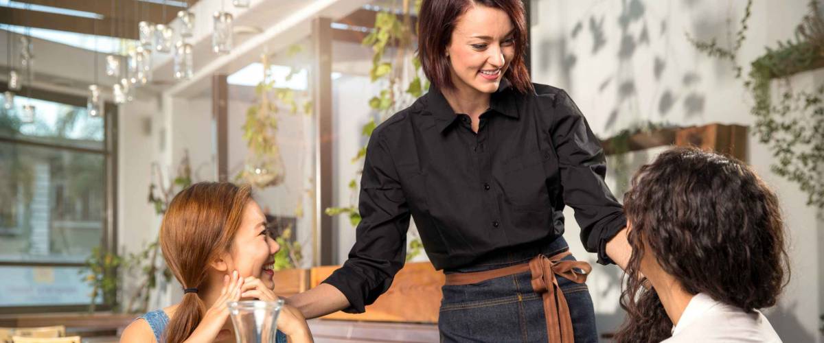 Friendly server laughing with customers