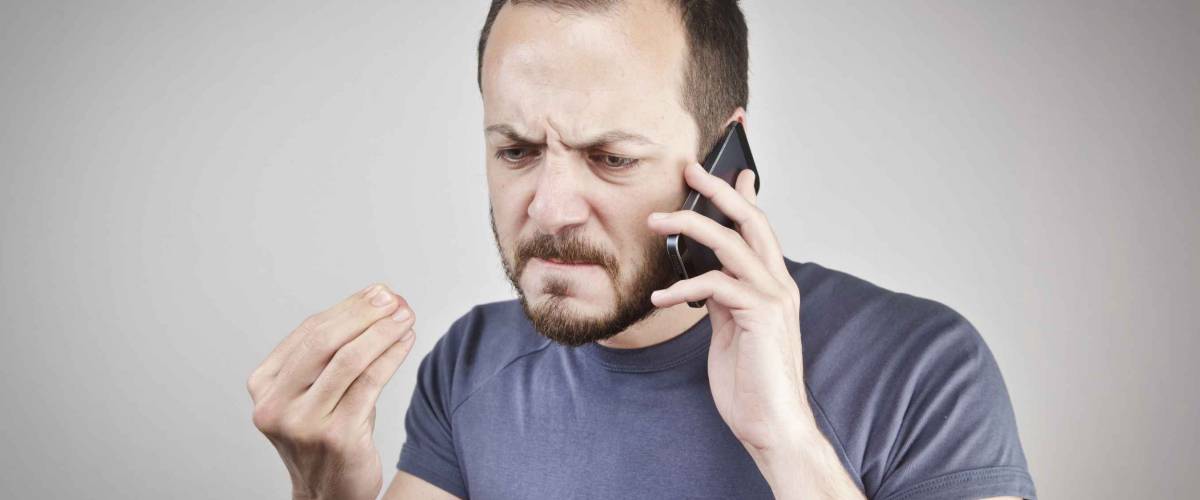 Angry man talking into phone