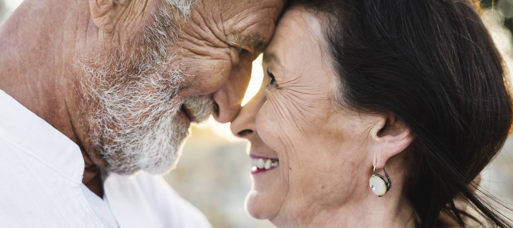 A mature couple embracing.