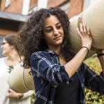 A group of young people move house.