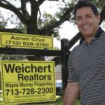 Real estate agent Aaron Cruz poses for a photograph
