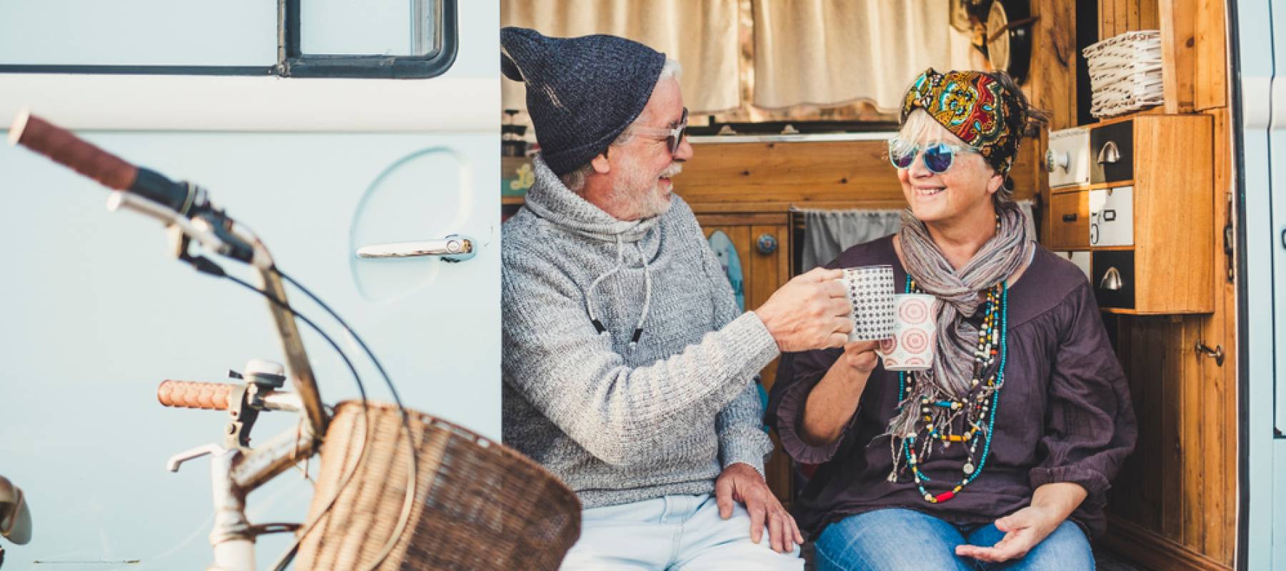cheerful mature people couple caucasian in a van sipping coffee