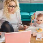 Women at home working with her infant next to her