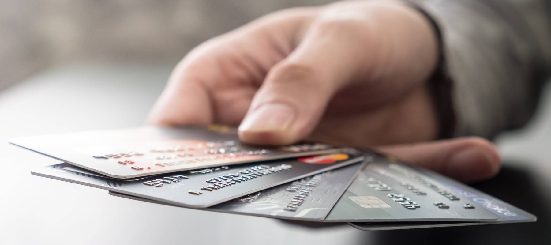 Male hands holding credit cards, soft focus.