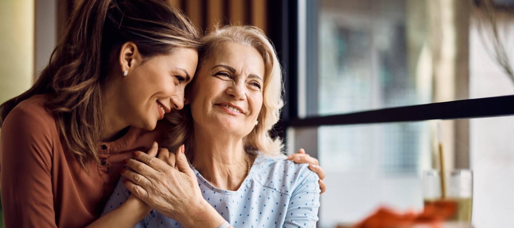 senior woman enjoying in daughter's affection
