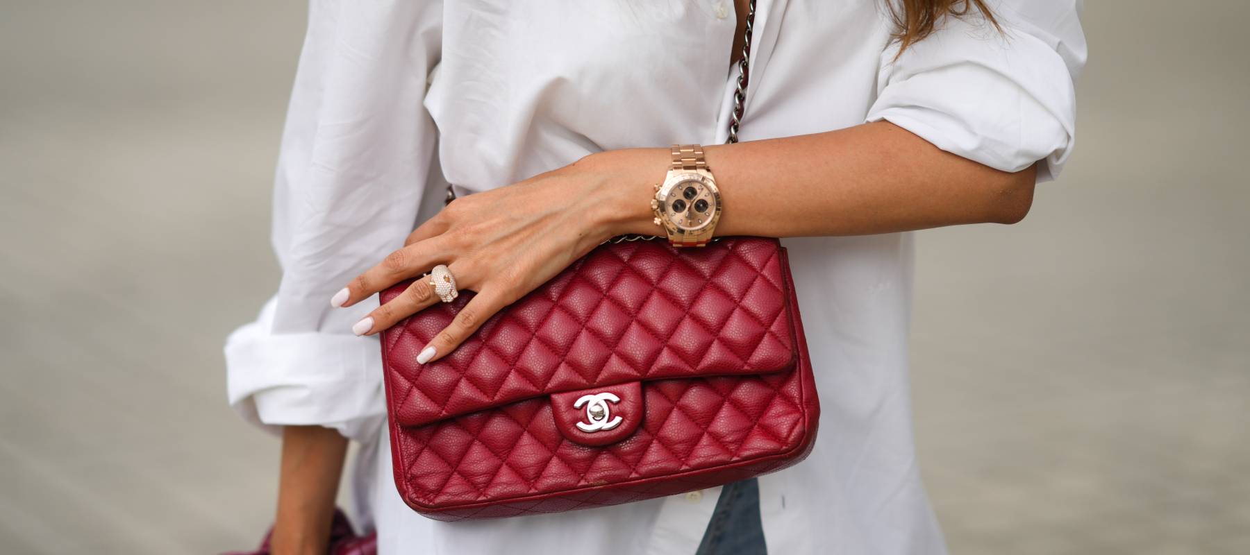 Patricia Contreras wears a burgundy quilted leather Chanel crossbody bag, a gold Rolex watch and a gold and diamond ring in Paris, June 3, 2021.