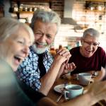 senior friends enjoying conversation and breakfast together