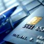 Credit card and ball pen on a laptop